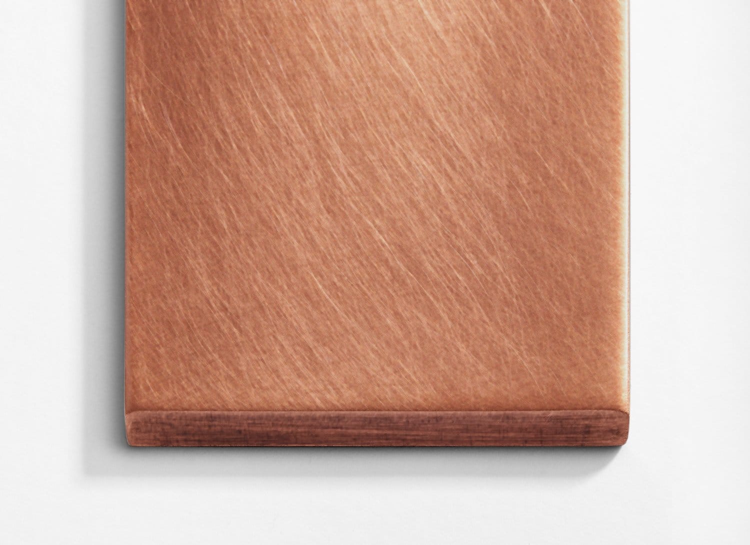 A copper plate on a white surface.