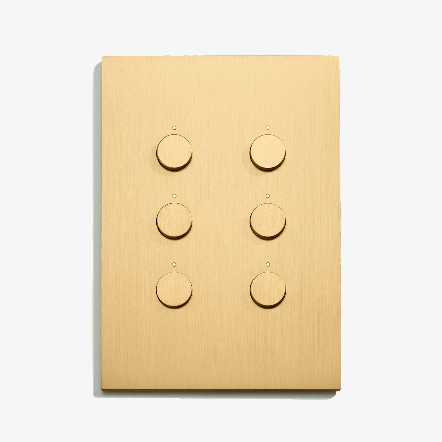 A light switch with four buttons on a white surface.