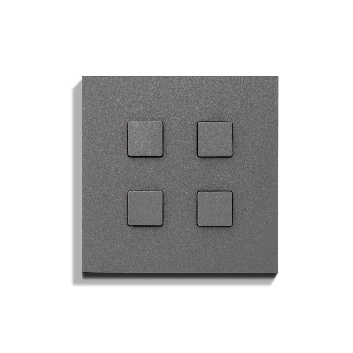 A grey wall plate with four squares on it.