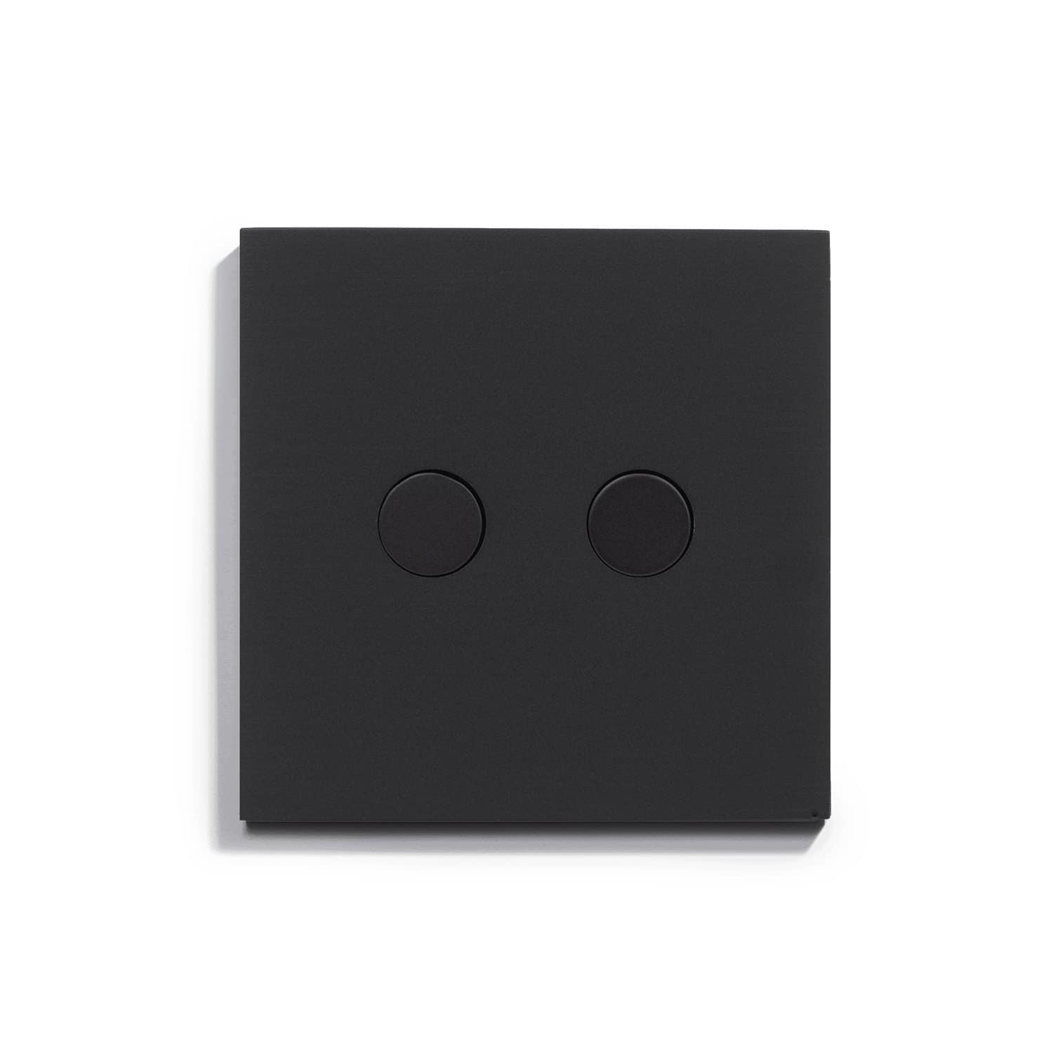 A black light switch on a white surface.