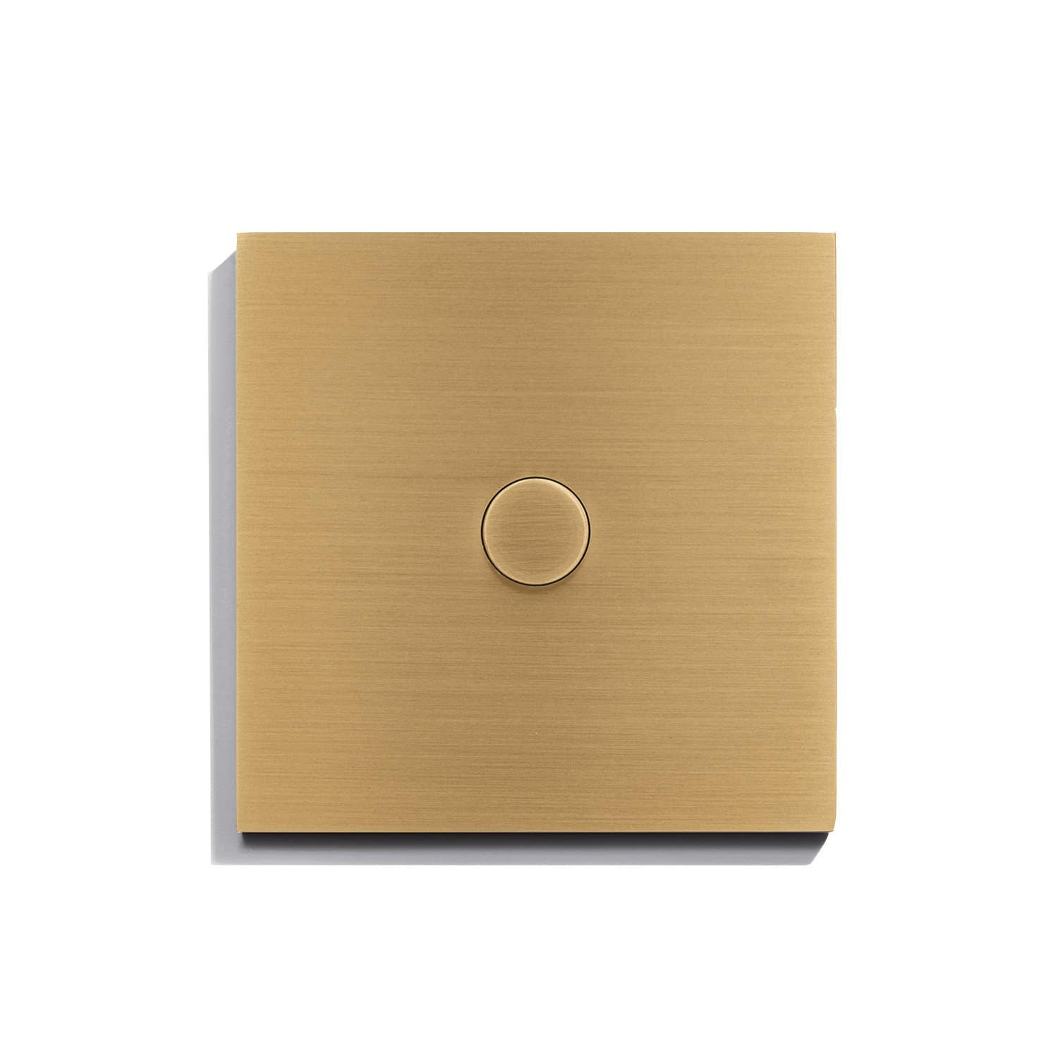 A gold light switch on a white surface.