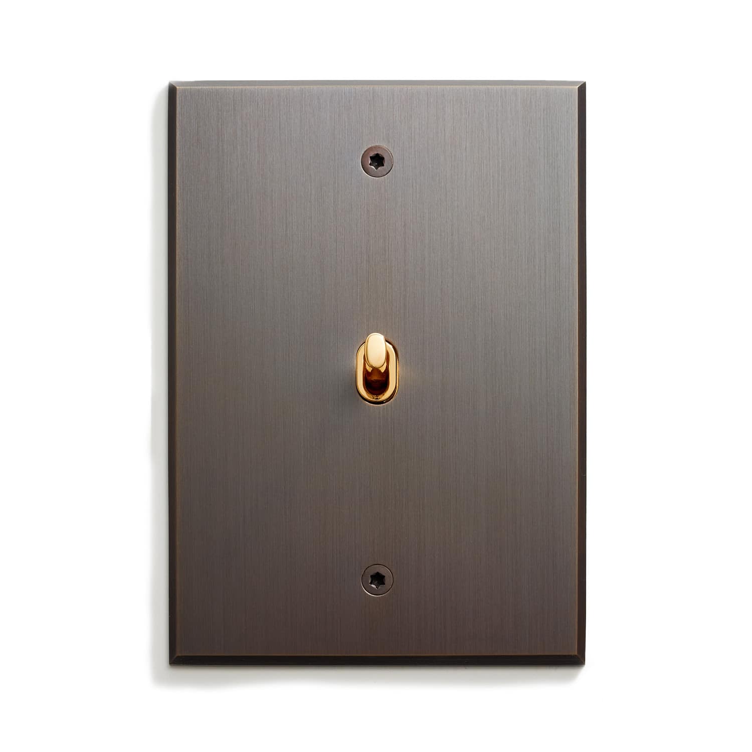 A light switch with a gold knob on it.