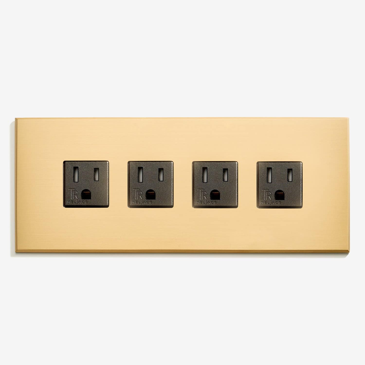 A gold wall plate with four outlets on it.