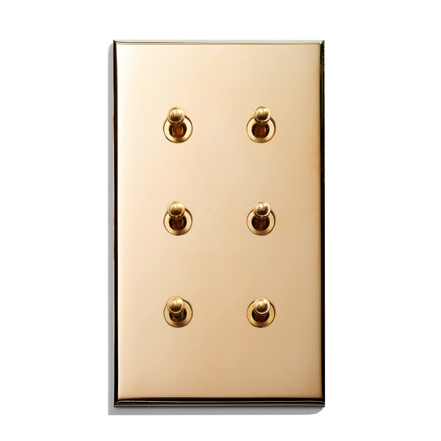 A gold plate with four buttons on it.