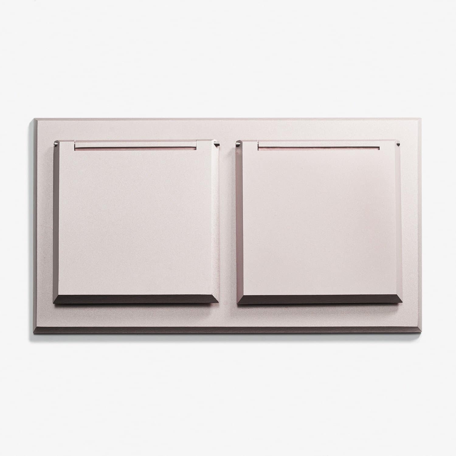 A wall mounted plate with two drawers on it.