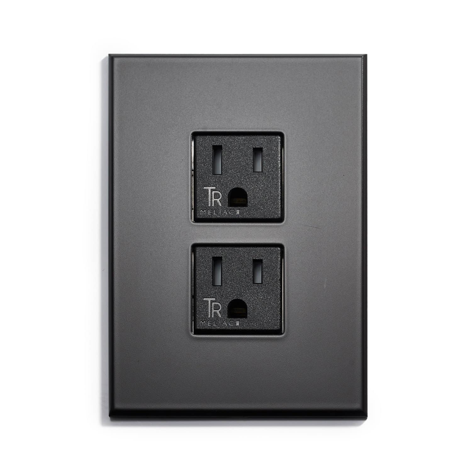 A black wall plate with two outlets on it.