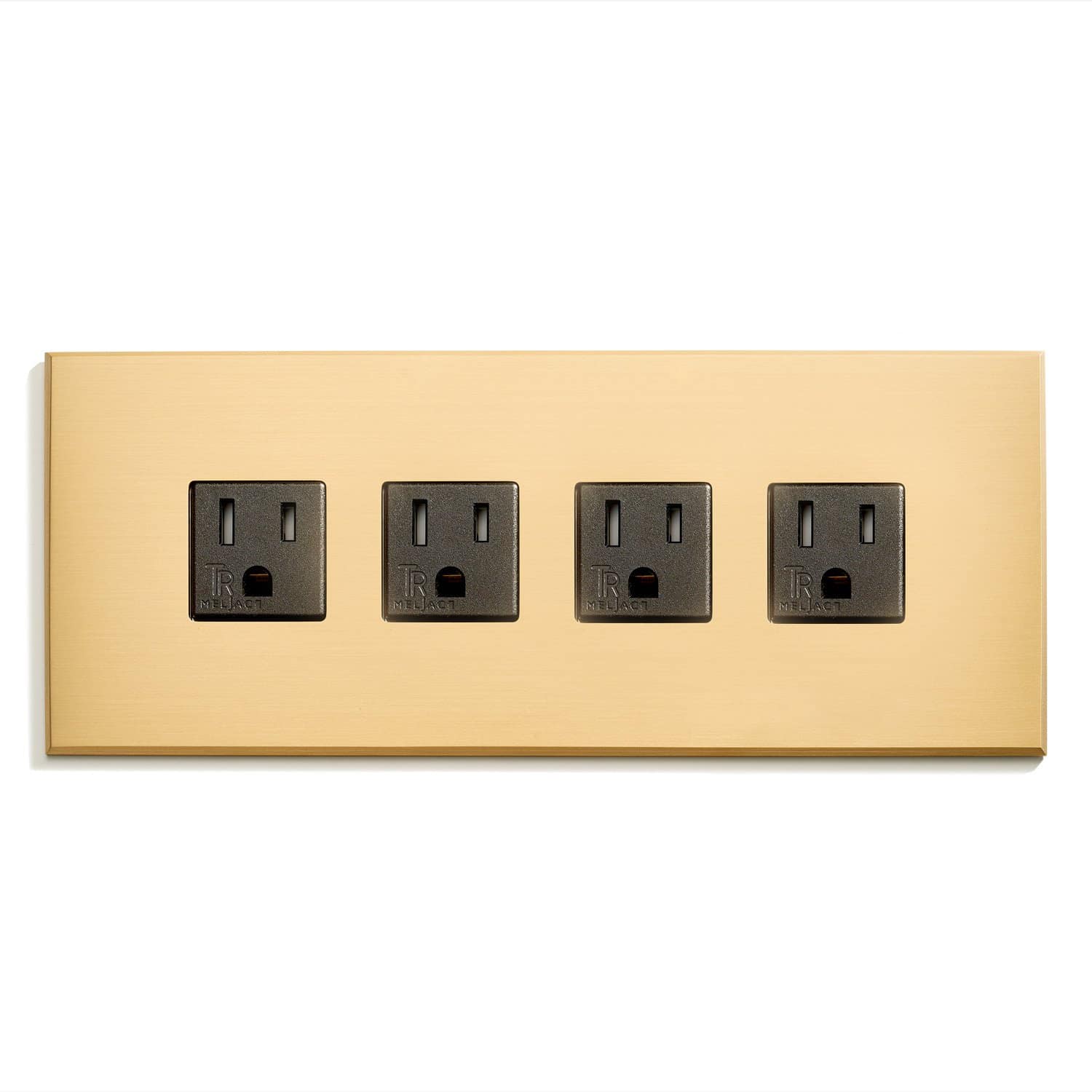 A gold wall plate with four outlets on it.
