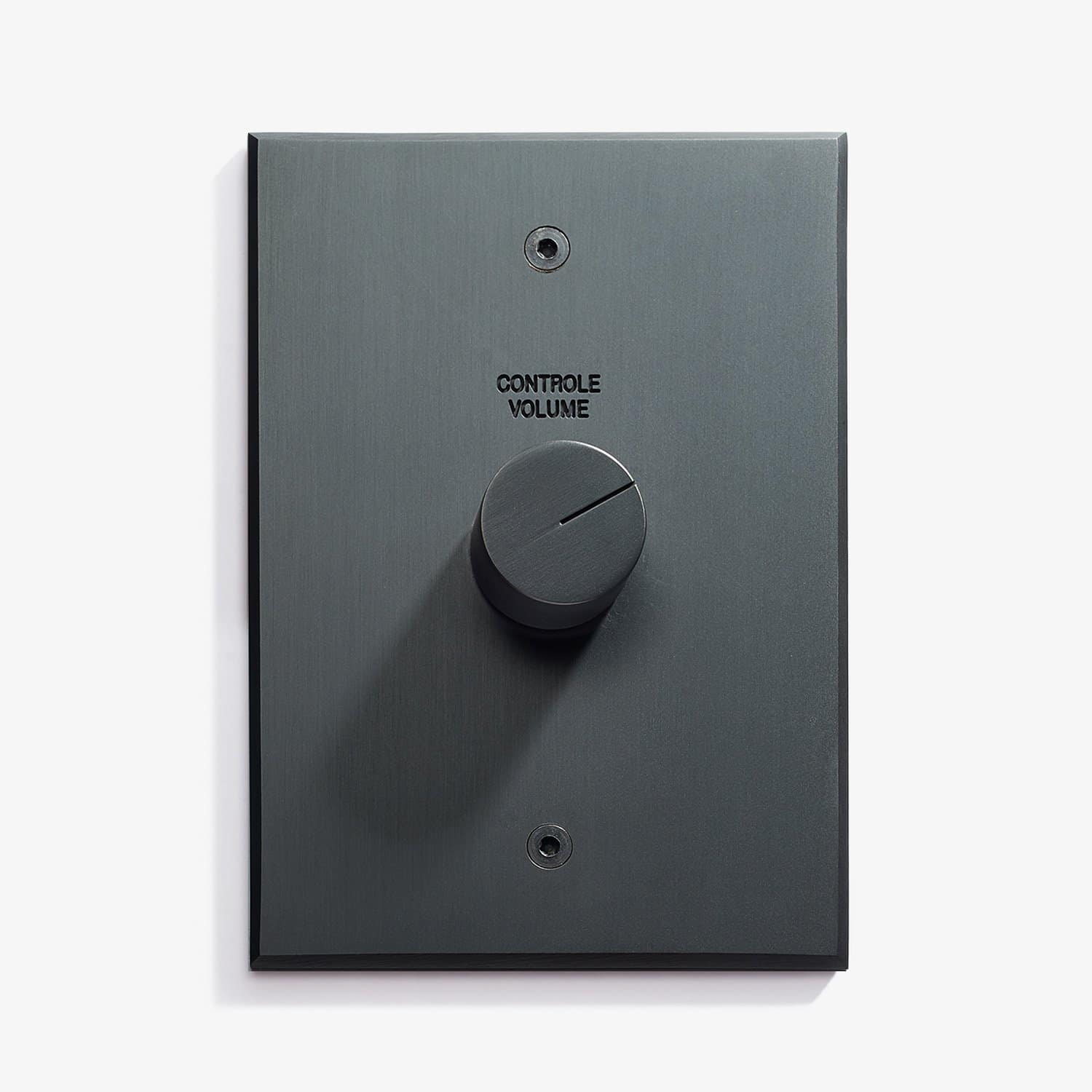 Wall-mounted volume control knob in a sleek design with label "controle volume" indicating a sound system's volume adjustment panel.