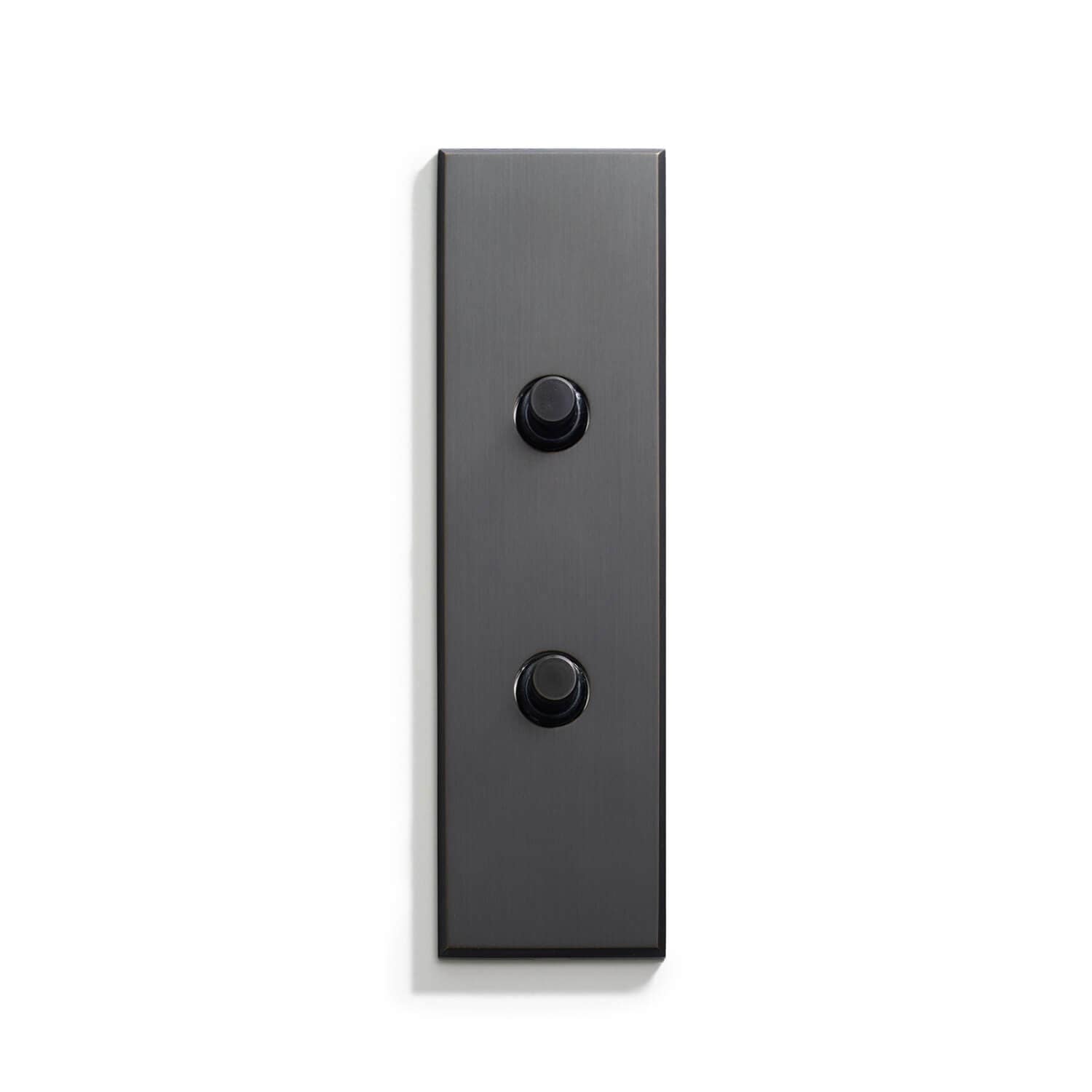 A rectangular object with two black buttons.