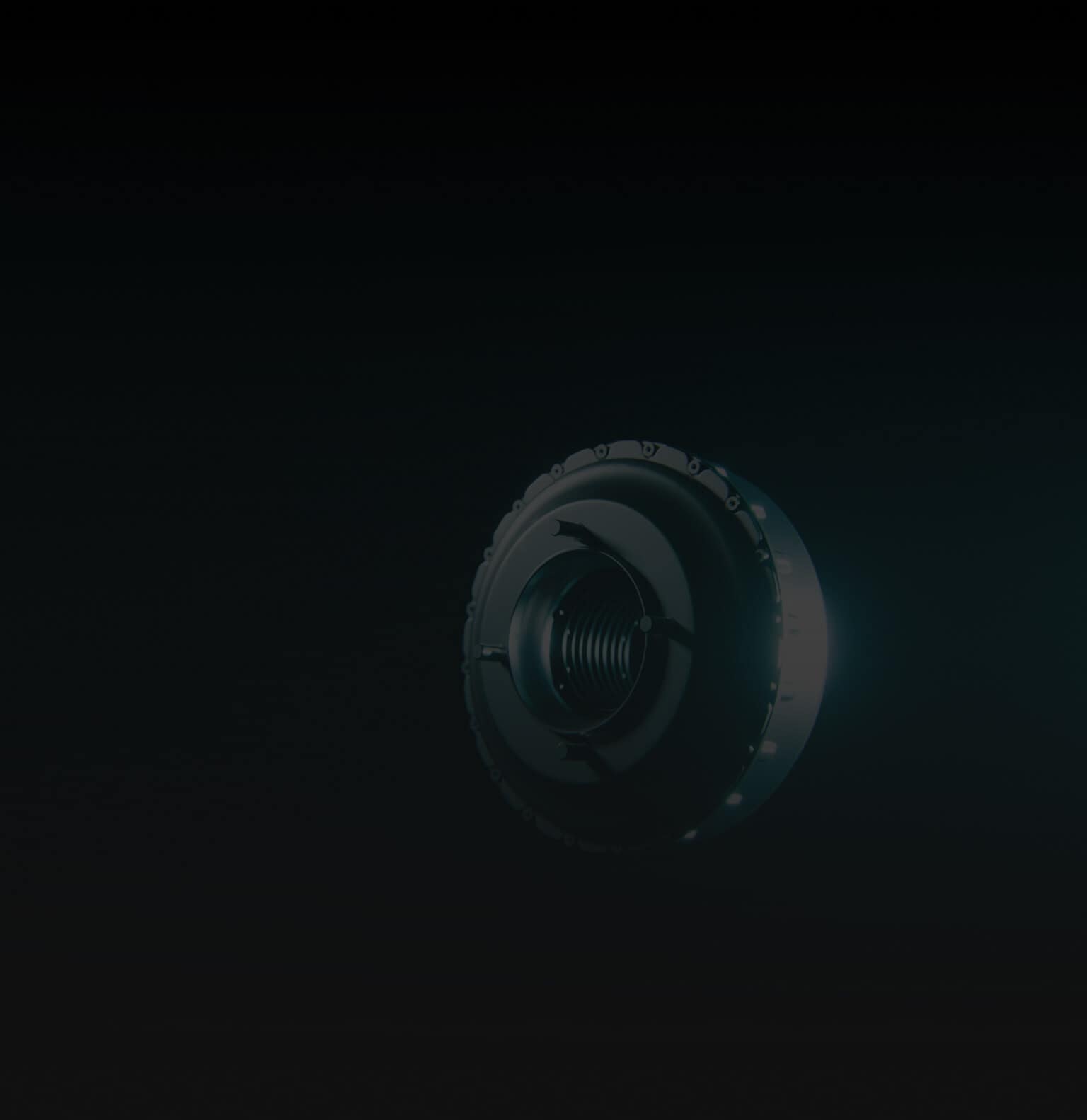 A close-up of a metallic, circular machine part or lens with a threaded center, illuminated against a dark, shadowy background.