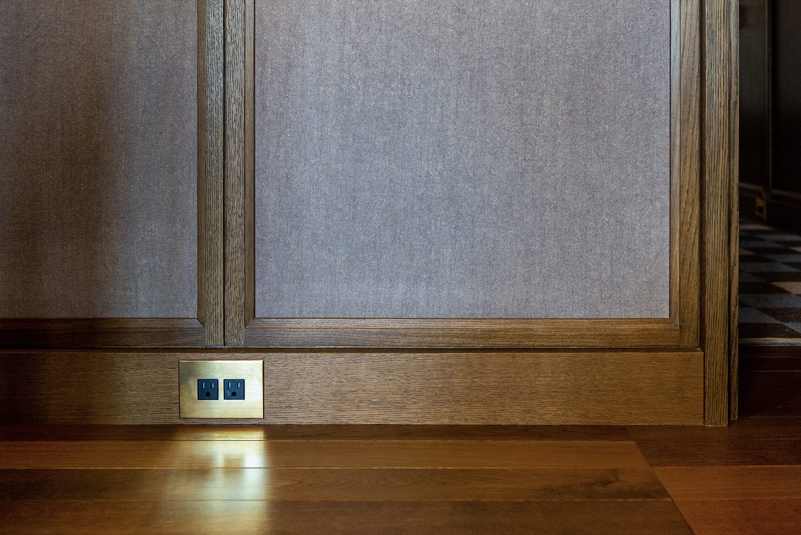A wooden floor in a room with a light on it.