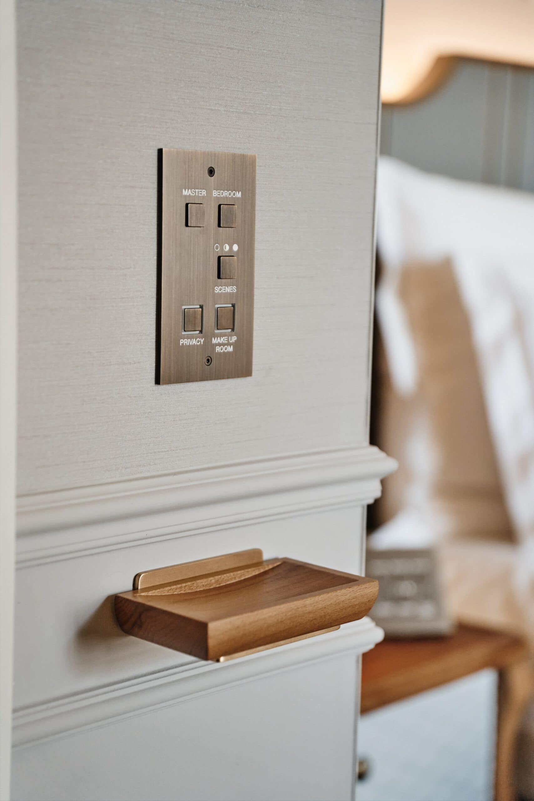 A wooden shelf with a switch on it in a hotel room.