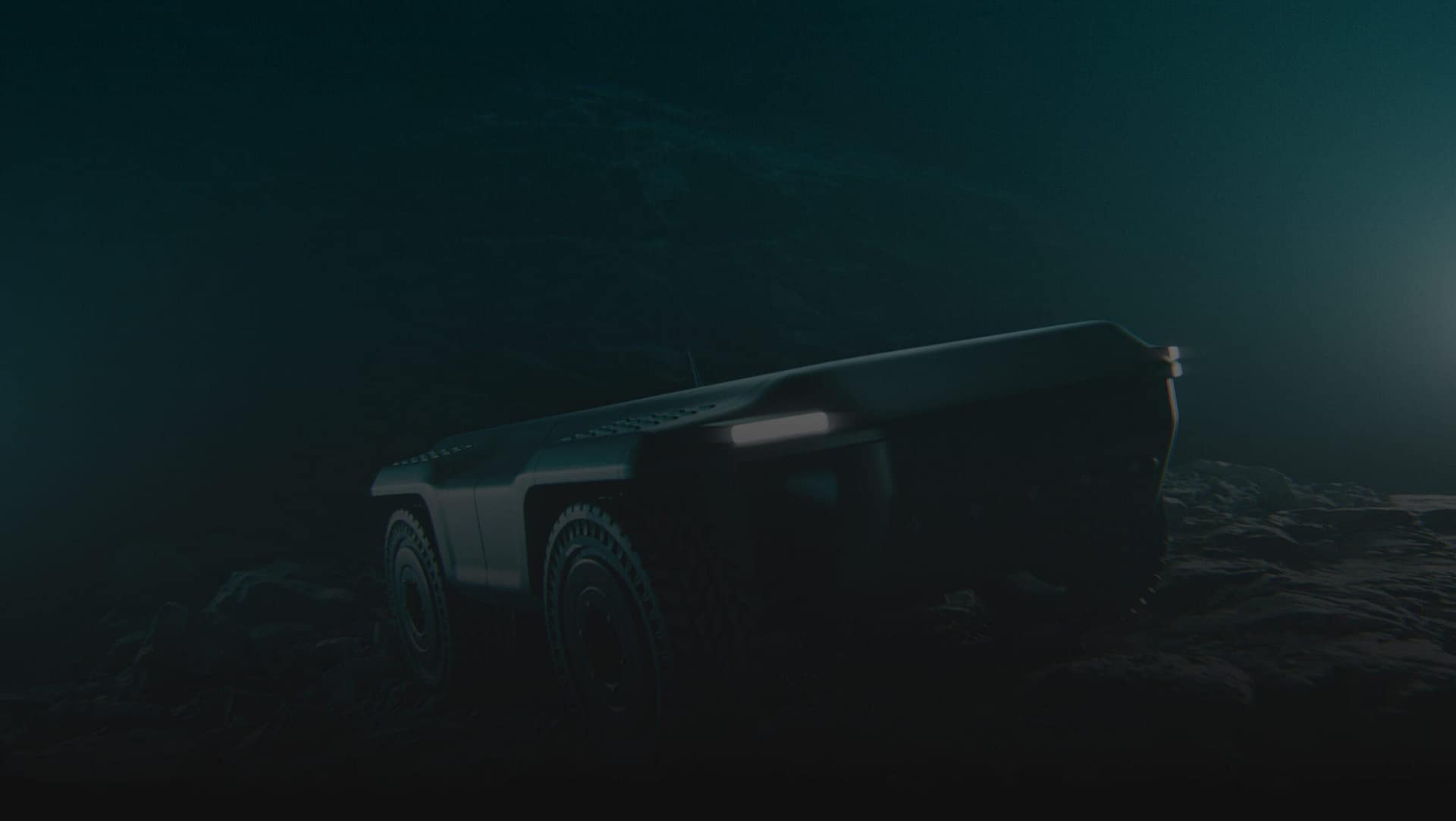 A dark, low-light image of a rugged, autonomous vehicle with large wheels and headlights, driving over rocky terrain. The scene appears to be set underwater or in a very dim environment.