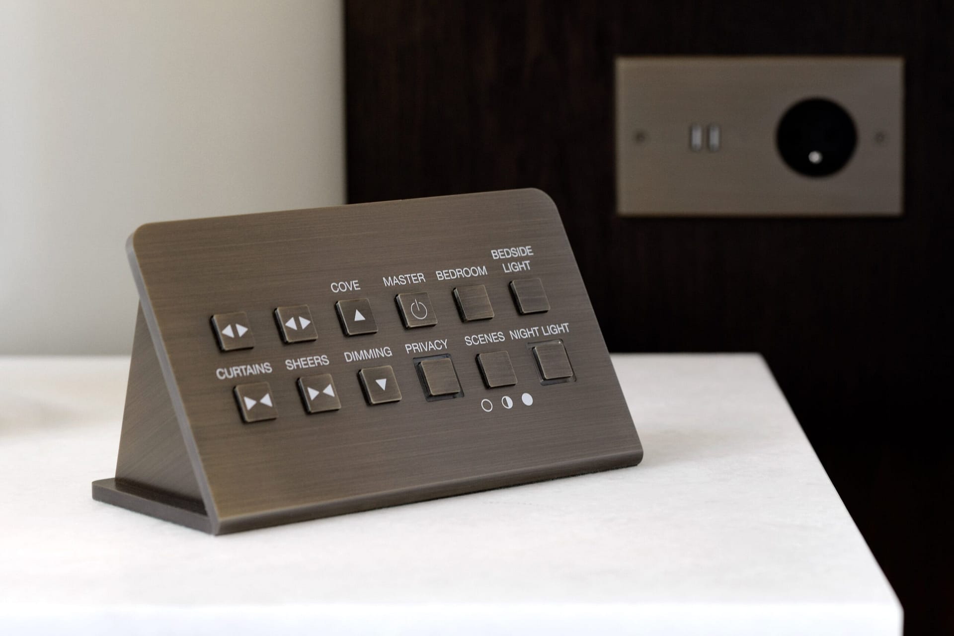 A brown remote control is sitting on a table.