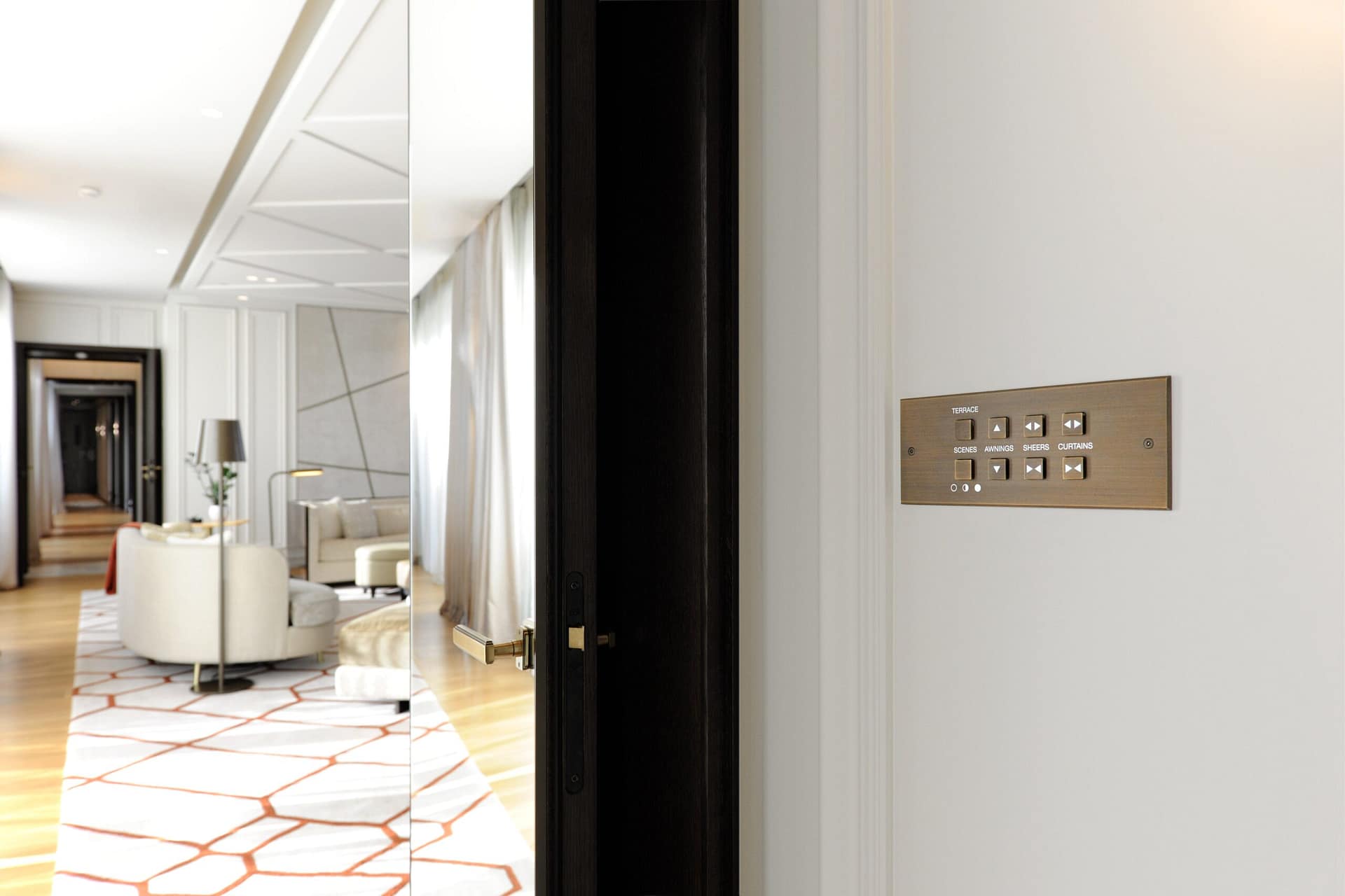 A hallway with a door and a mirror.