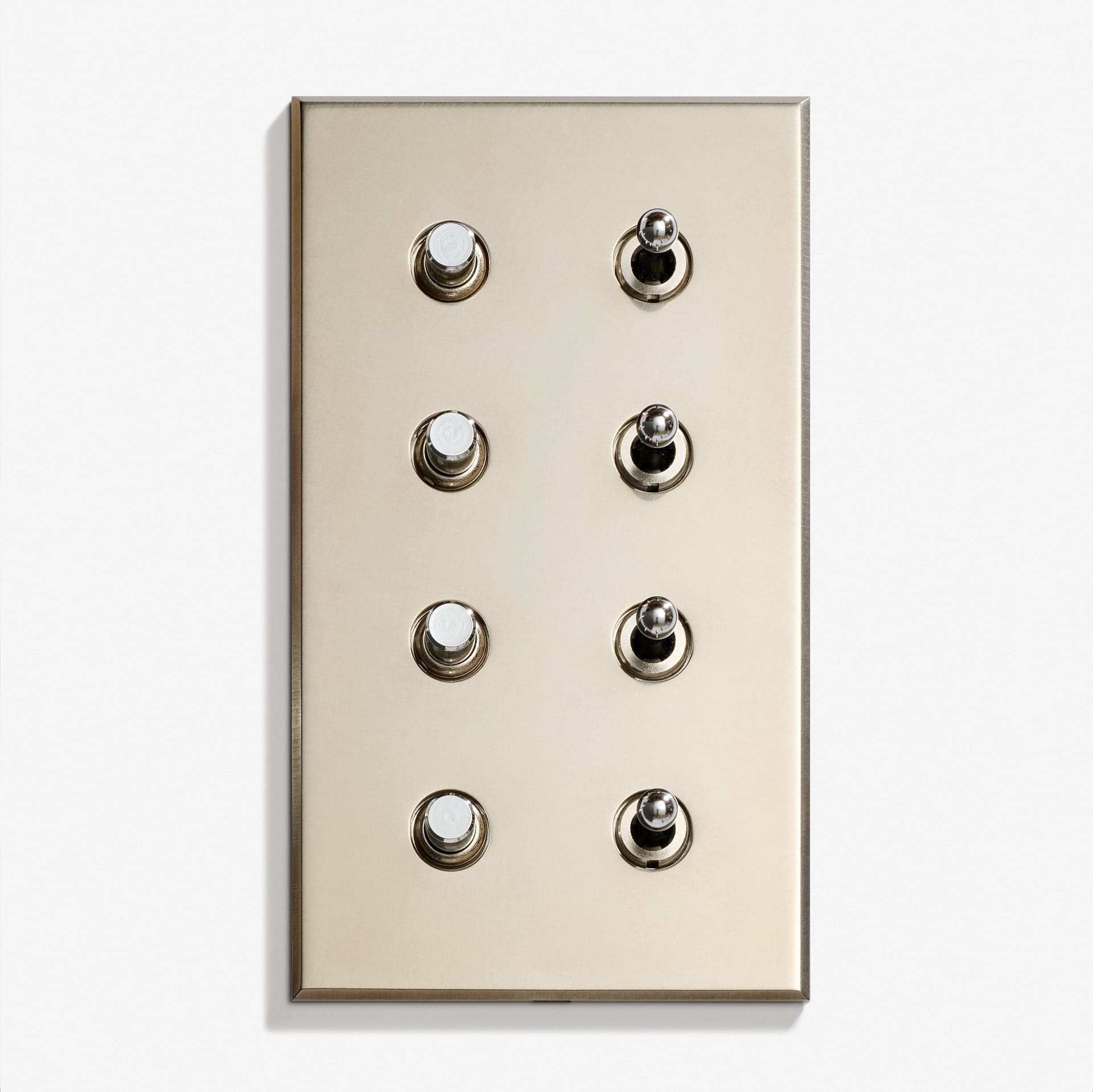 A brass Classique Keypad 82 x 144 wall plate featuring six evenly spaced toggle switches arranged in two vertical columns of three on a white background.