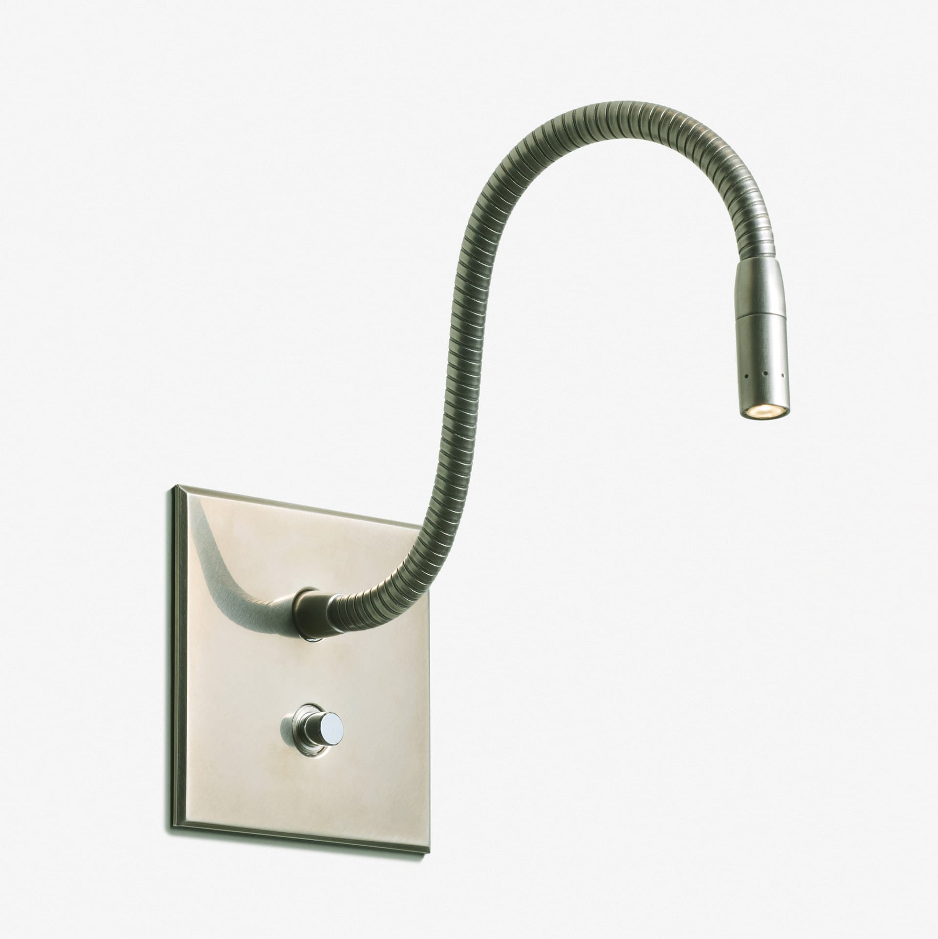 A wall-mounted, flexible gooseneck reading light with a small cylindrical LED lamp, metallic finish, and a round on/off switch on the rectangular wall plate.