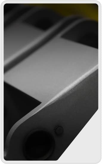 Close-up of a metallic, industrial component with smooth, gray surfaces and curved edges, featuring a round hole and a bolt, partially out of focus.