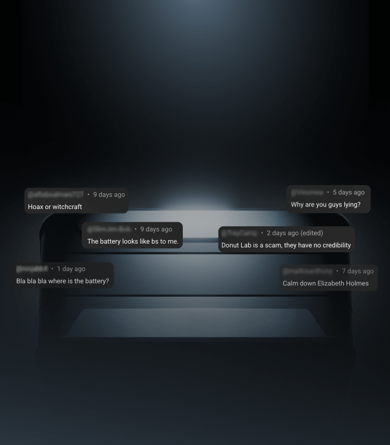 A dark, futuristic object is partially visible against a black background, with negative comments about credibility and skepticism floating above it in grey speech bubbles.