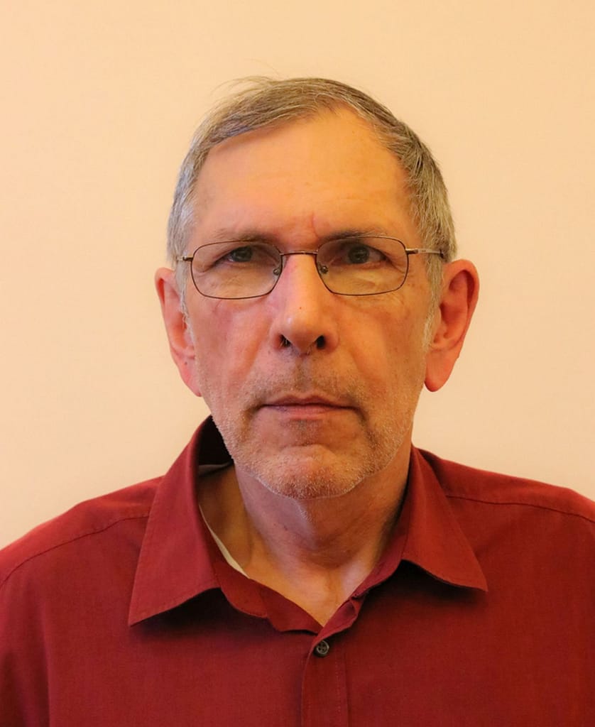 A man wearing glasses and a red shirt.