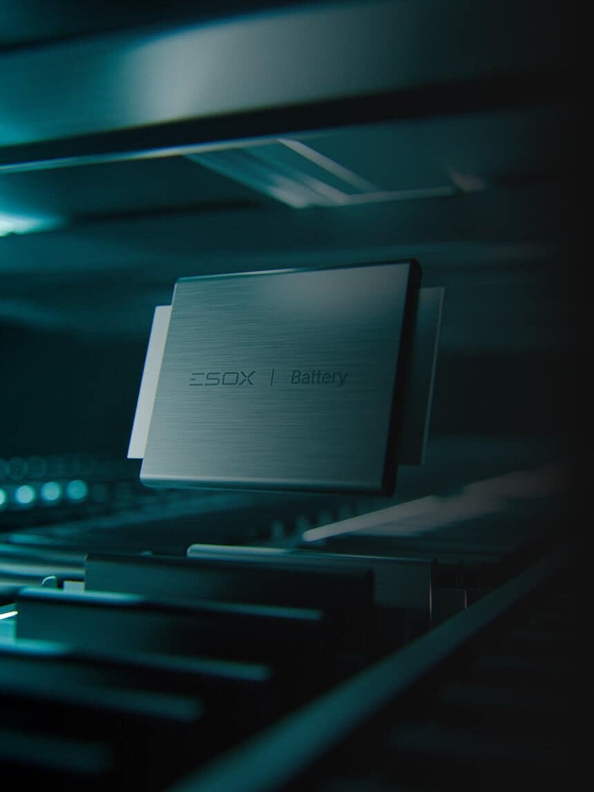 A sleek rectangular battery labeled "ESO X | Battery" hovers above a metallic surface in a dimly lit, futuristic setting with blue-green lighting.