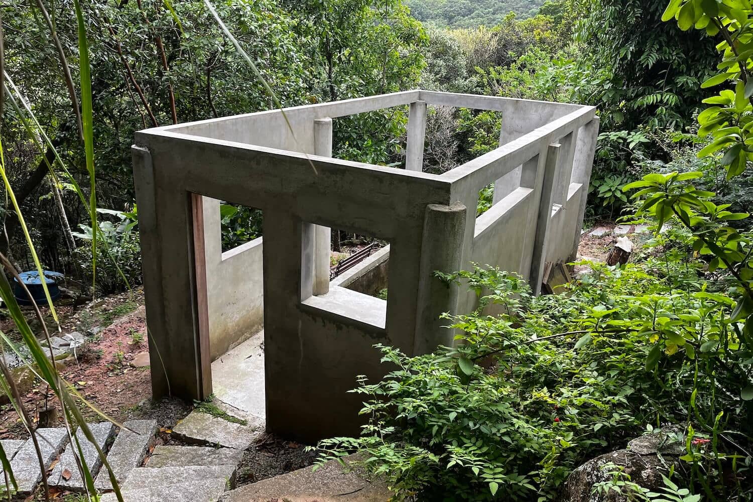 A concrete structure in the middle of a forest.